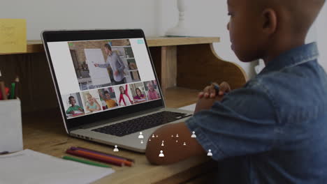 animation of icons and data processing over african american schoolboy online schooling on laptop