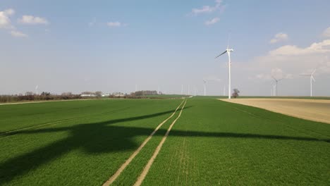 a-movie-shot-from-a-drone,-the-shadow-of-a-windmill-in-the-field