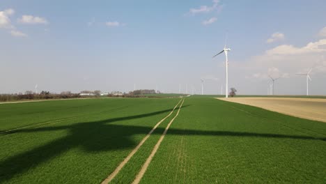 a movie shot from a drone, the shadow of a windmill in the field