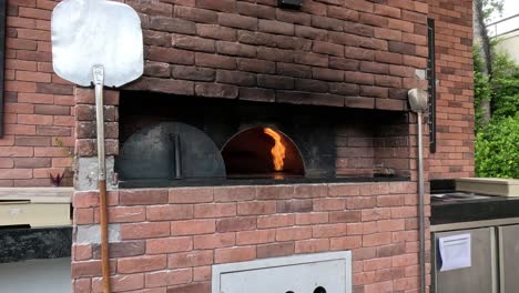 making cotton candy with a pizza oven backdrop.