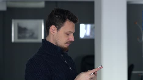 young man using he's cell phone, mobile phone , browsing on the internet and messaging concept