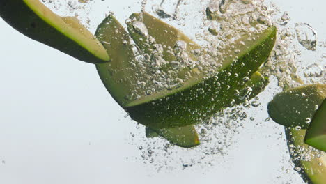 avocado pieces splashing liquid in super slow motion close up. vitamin vegetable