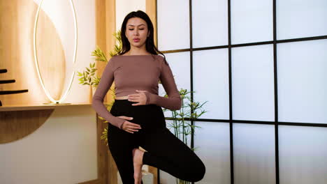 pregnant woman on yoga mat