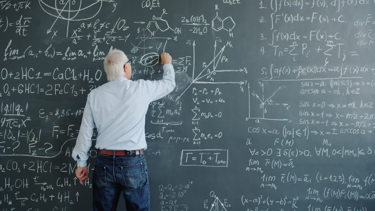 Senior Professor Writing Equations on a Blackboard