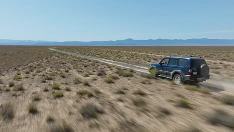 dust from vehicle speeding offroad in charyn canyon national park, kazakhstan