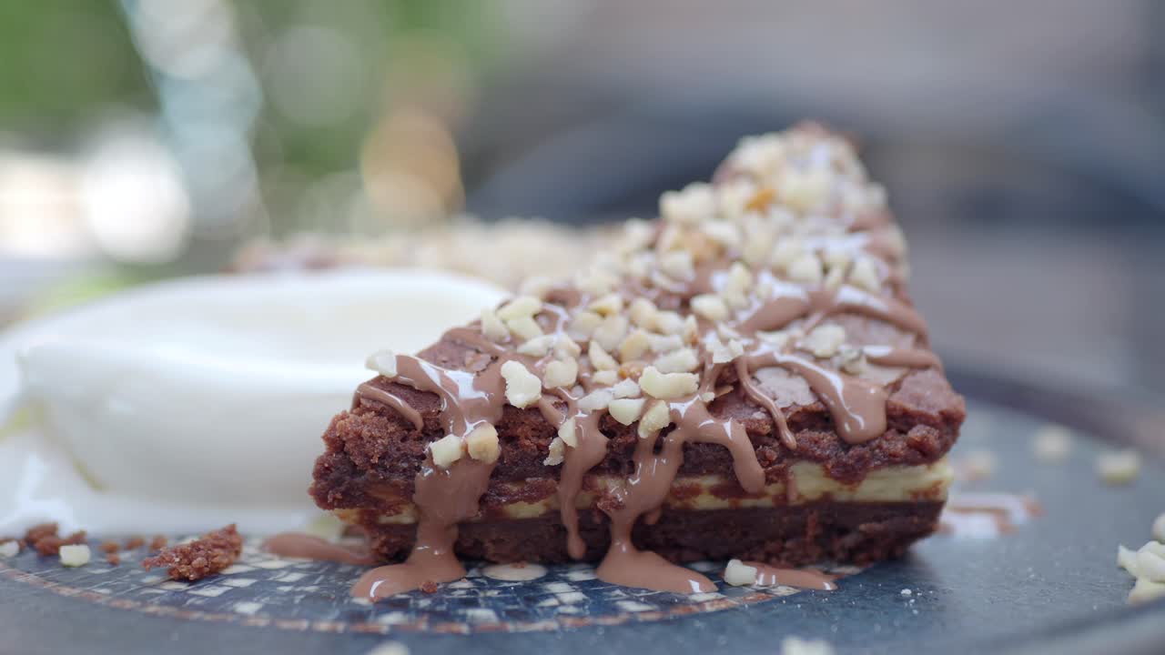 Chocolate cake with nuts and chocolate sauce