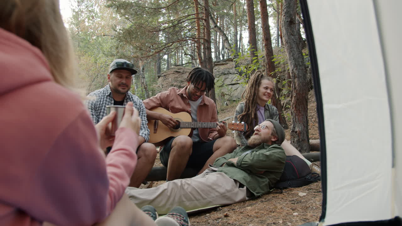 Friends Camping and Making Music in the Woods