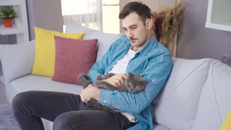 Thoughtful-man-loves-his-gray-cat.