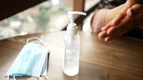 hand sanitizer and face mask on a table