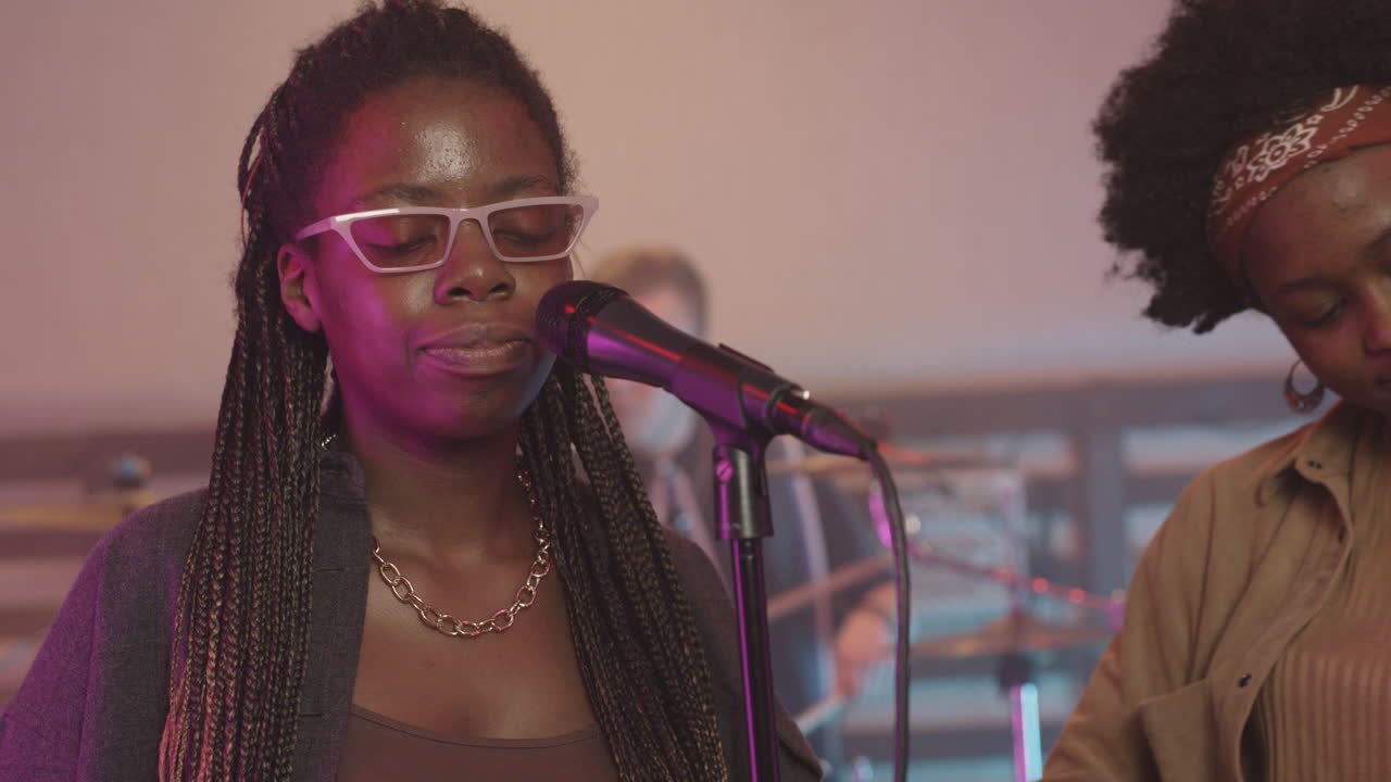 Multiethnic Music Band Rehearsing In Recording Studio 8