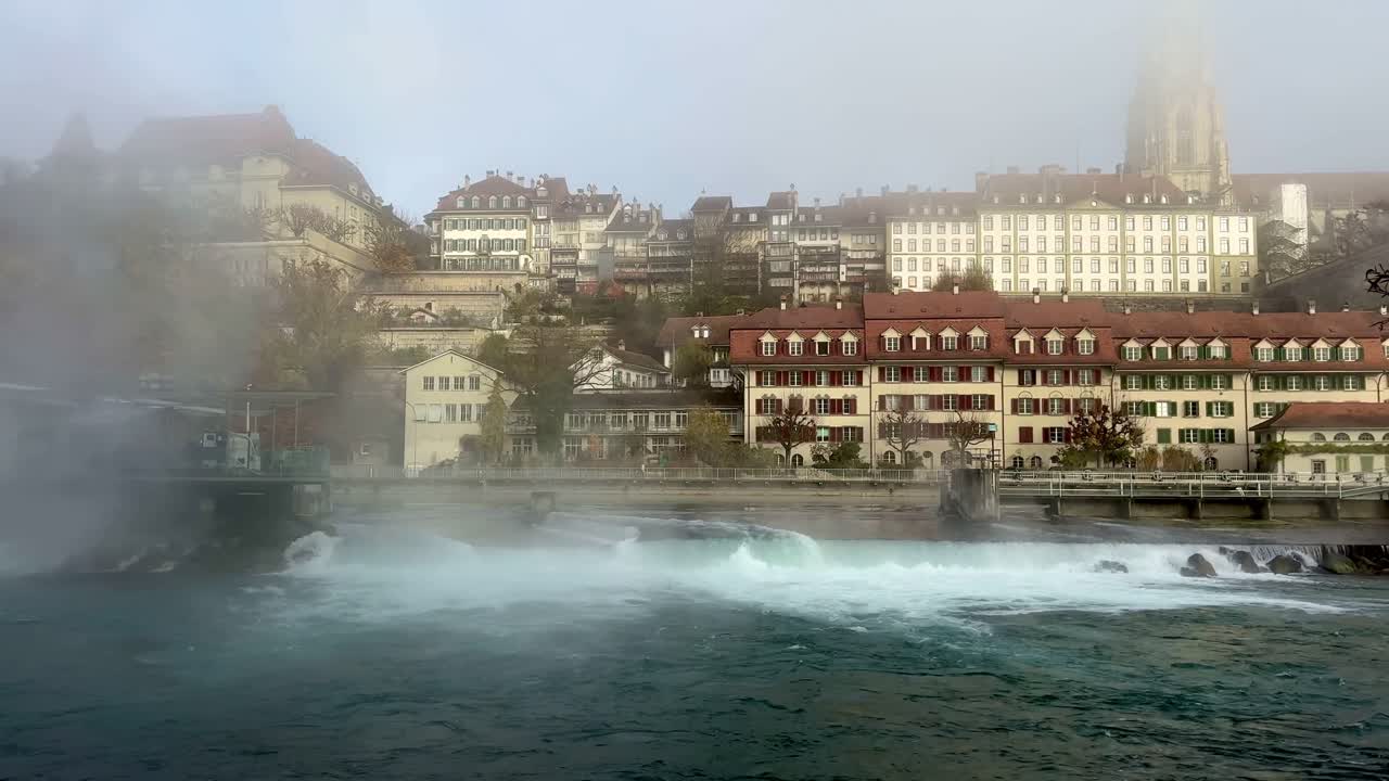 Foggy morning in Berne with mist over Aare River and skyline.