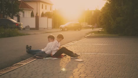 schoolboys prepare for exam reading textbooks on pavement