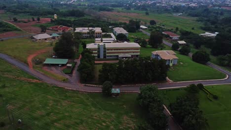 aerial of a beautiful resort surrounded by lush green fields in rural nigeria, africa. pull back view of horticultural research institute, nihort.