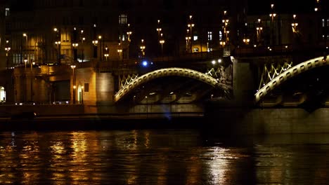 Budapest-city-center-view-with-Margit-Bridge-and-Danube-river-at-night,-light-reflections,-distant-panoramic-shot