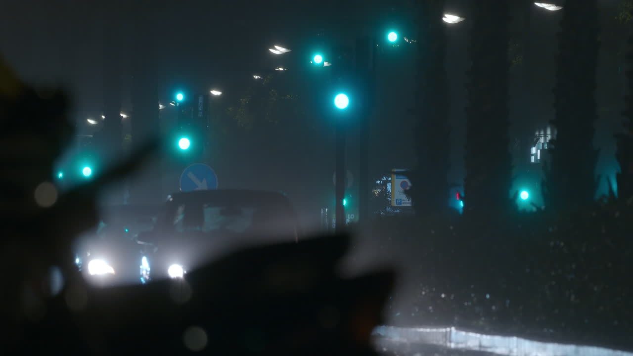 Dazzle lights of cars in the city at rainy night