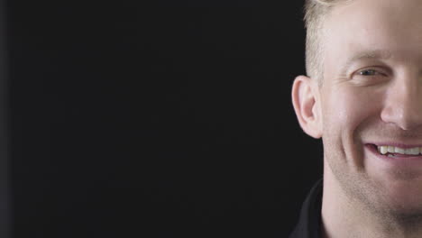 portrait-close-up-of-young-blonde-man-smiling-happy-satisfaction-successful-handsome-caucasian-male-isolated-on-black-background