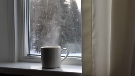 hot drink on a windowsill on a snowy day