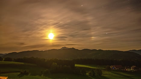 timelapse of mountainous attersee landscape during evening with stars peeking through clouds