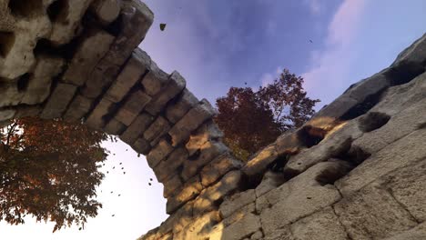 ancient ruins with autumn leaves and a dramatic sky