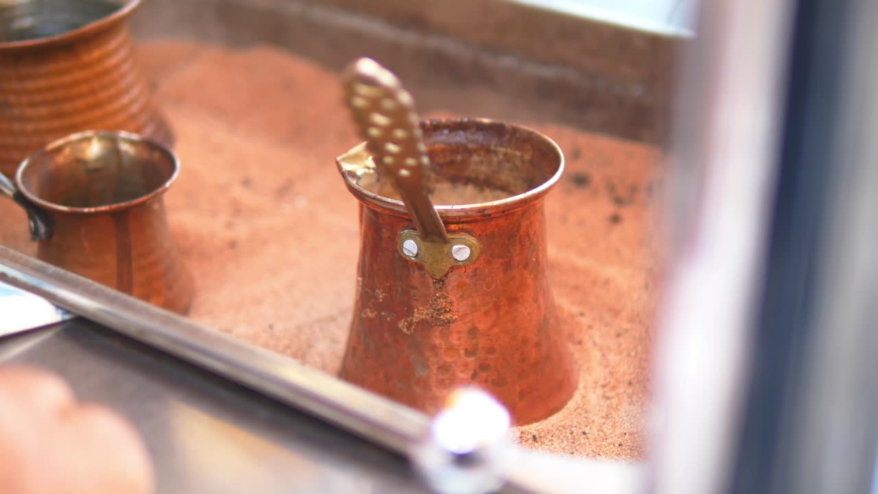 Traditional Turkish Coffee Preparation in Hot Sand