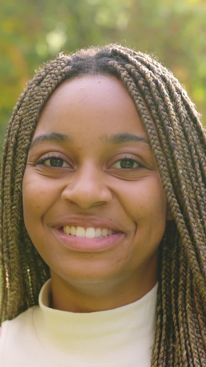 Portrait of a young woman with braids smiling