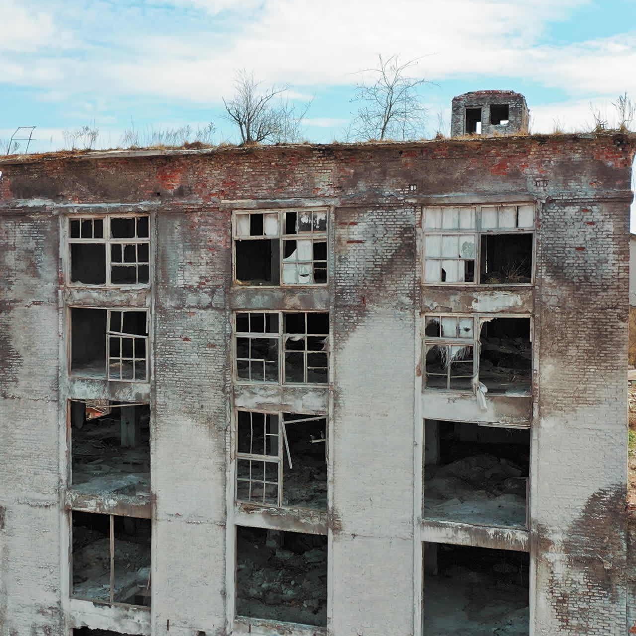 Aerial view of an old factory ruin and broken windows. Old industrial building for demolition.
