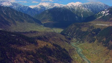 A-picturesque-village-with-beautiful-watery-scenes-round-snowy-mountains-and-river,-as-well-as-charmingly-crafted-greenery