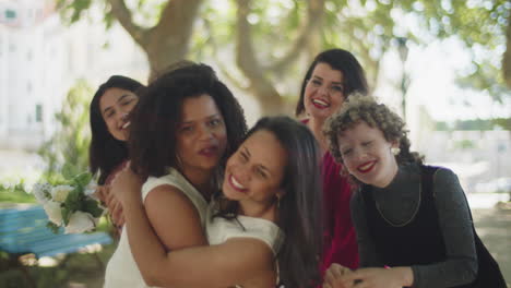 habbpy lesbian couple celebrating wedding with friends in the park