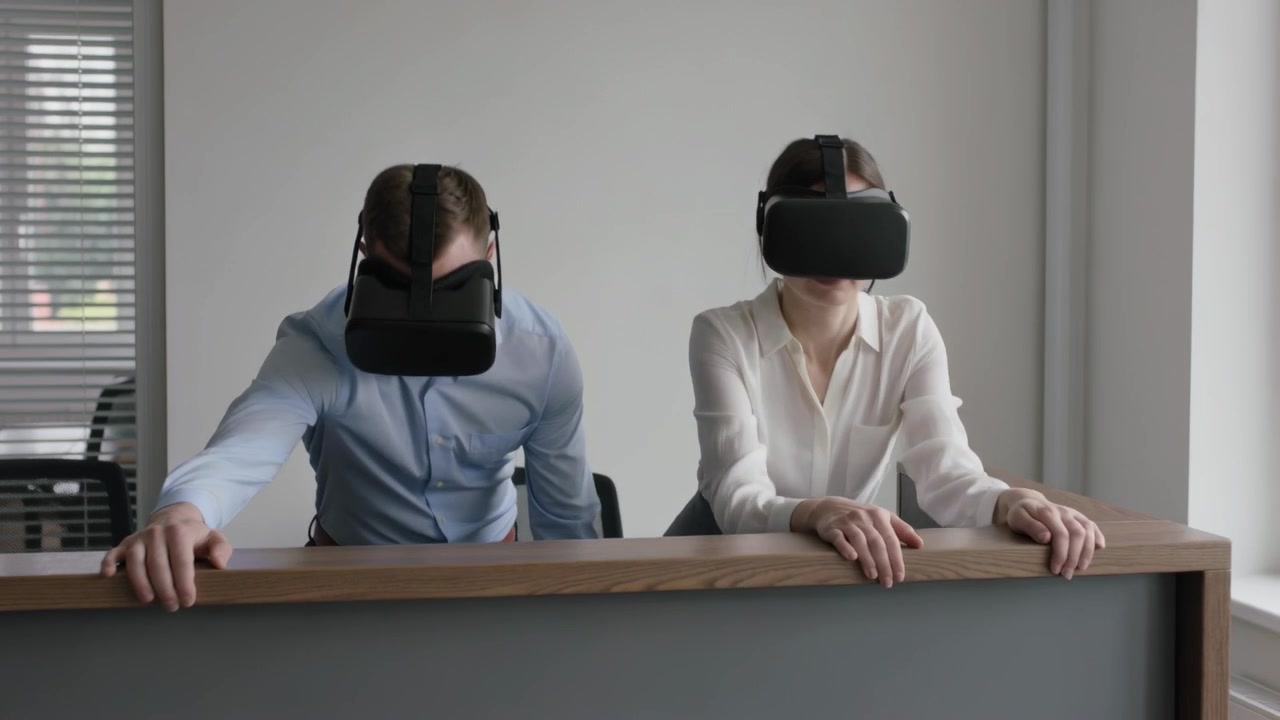 Leaning two staff responding to VR simulation at reception desk, wearing headsets and office attire