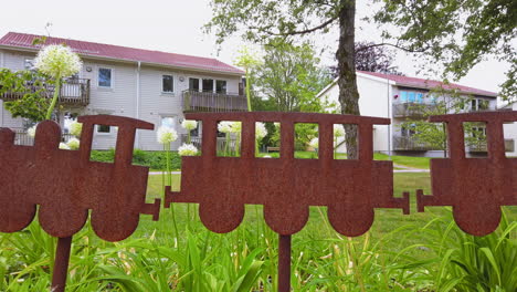 train shaped garden ornament, houses in background. dolly left