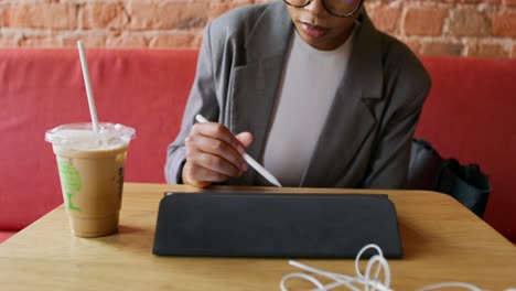 woman working on tablet in a cafe