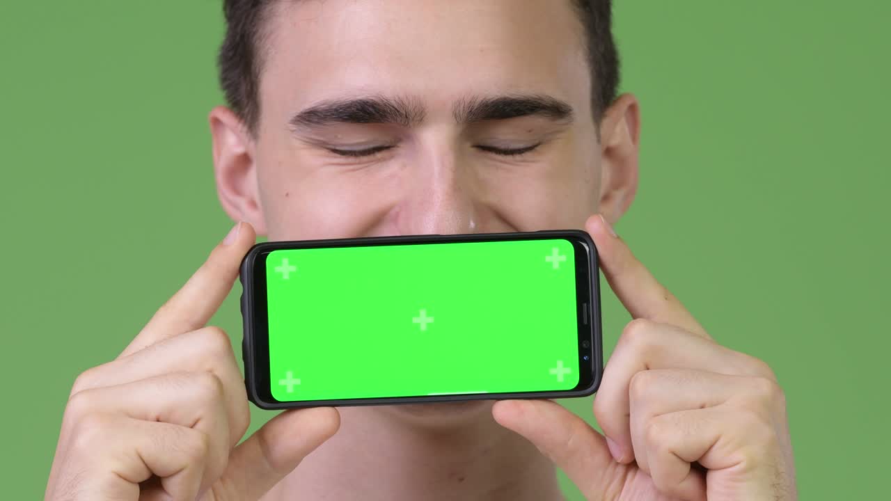 Young handsome man showing phone