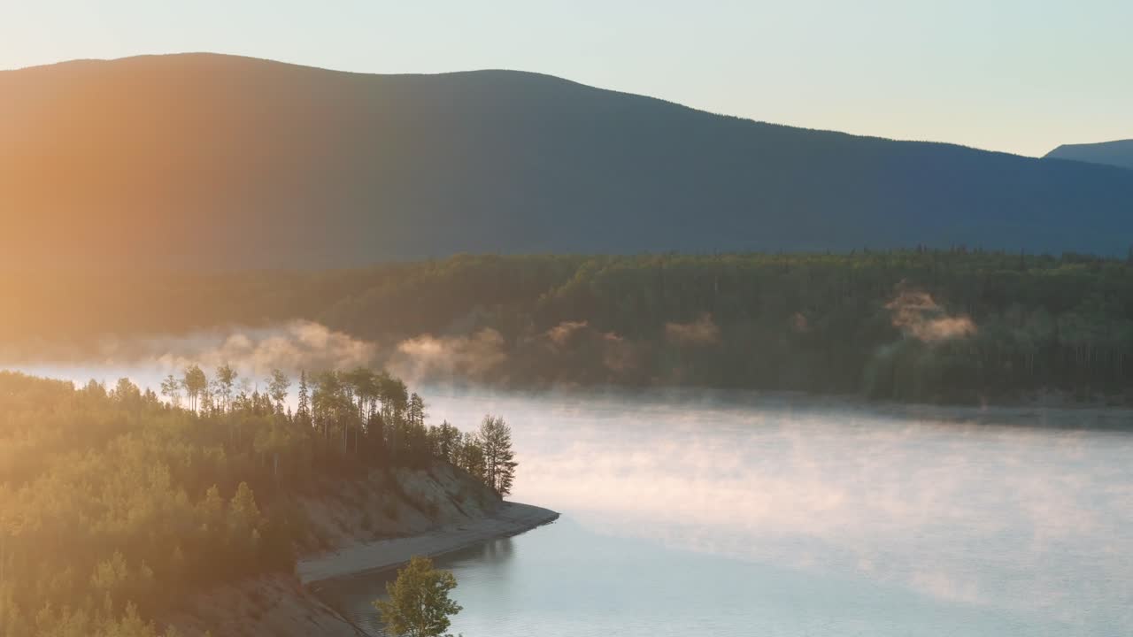 CGI drone shot of a foggy northern lake with moody atmosphere, forest reflections, and cinematic natural beauty for dramatic landscape visuals.