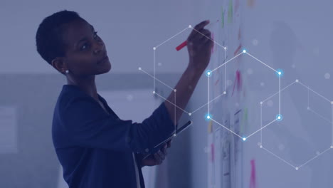 animation of data processing over african american businesswoman in office