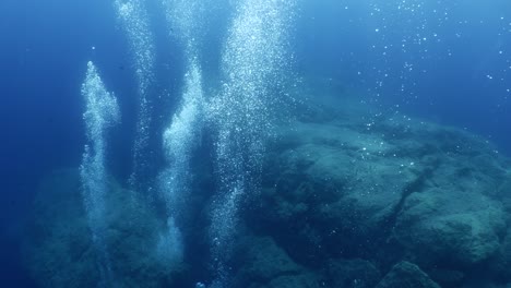 underwater close to surface with the sky view ocean scenery sun beams sun rays and air bubbles slow relaxing ocean backgrounds