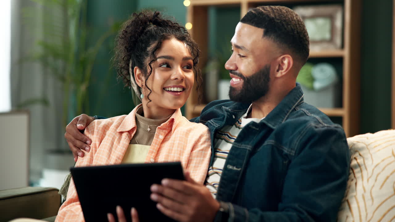 Couple enjoying time together with tablet at home
