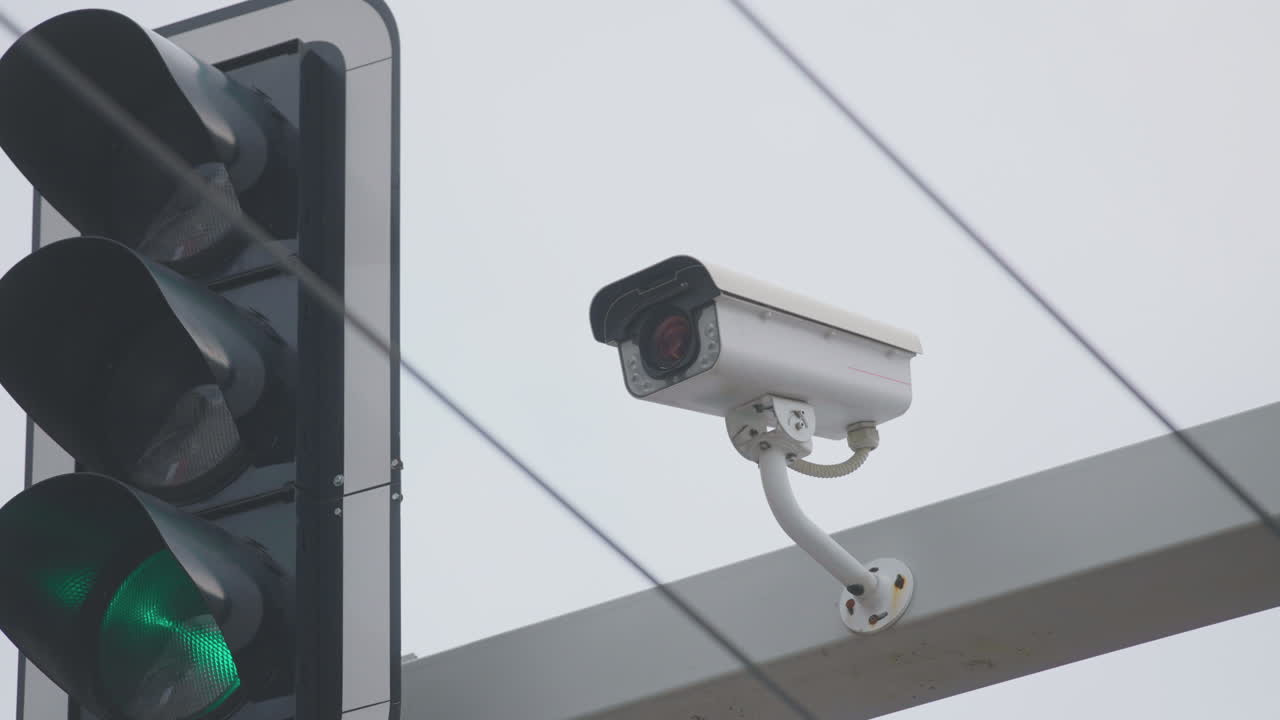 Traffic light with surveillance camera