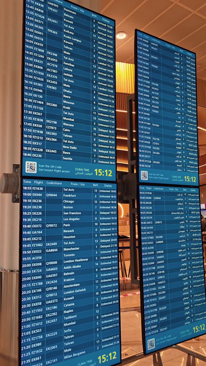 Flight information schedule screens installed at Dubai International Airport, Terminal 3, UAE.