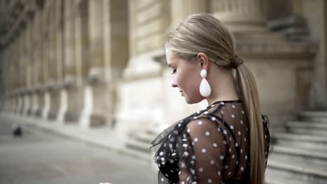 stylish woman in polka dot dress in paris