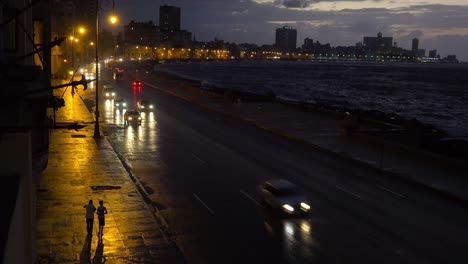 beautiful night shot of the malecon in havana cuba with cars passing