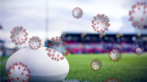 covid-19 cells against rugby ball on sports field