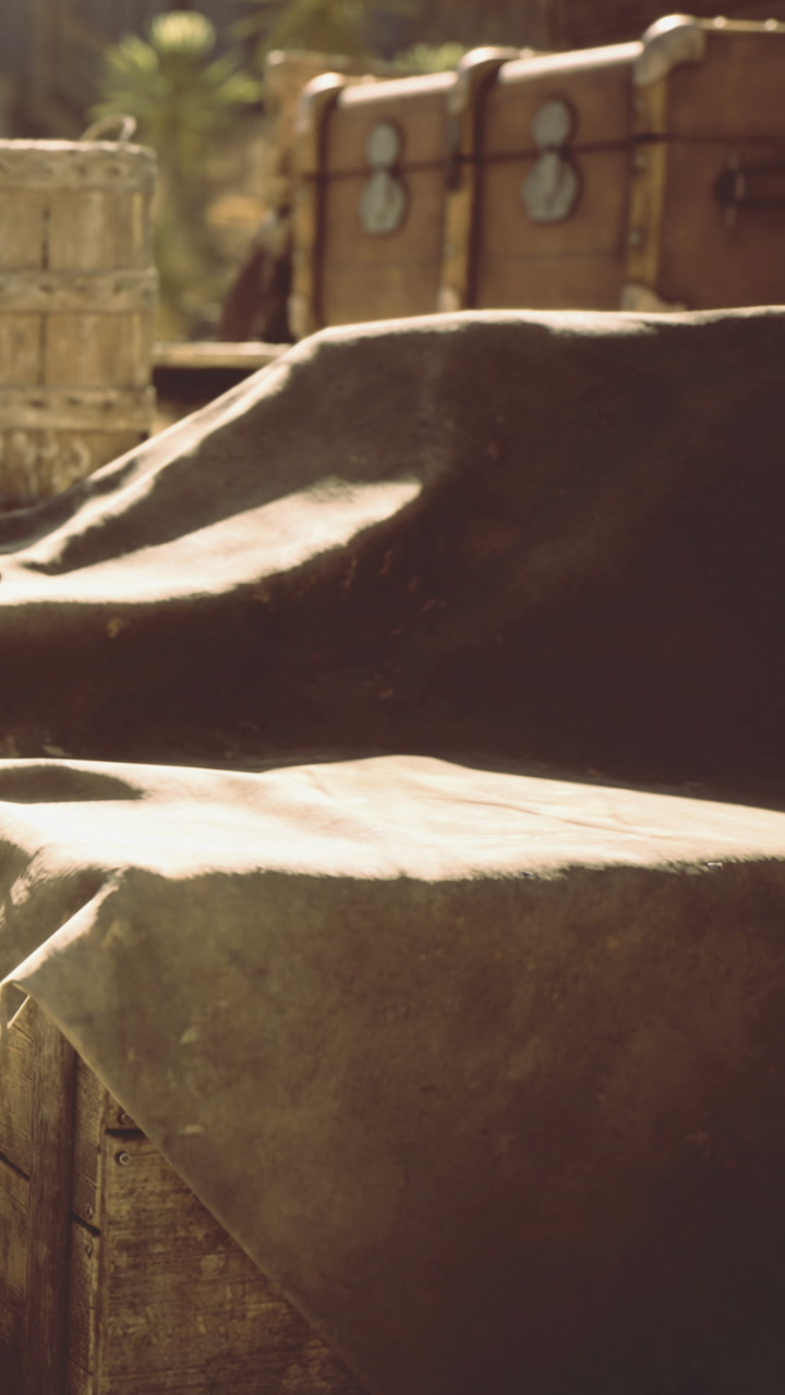 Mysterious treasures waiting under a dusty canvas in the golden sun
