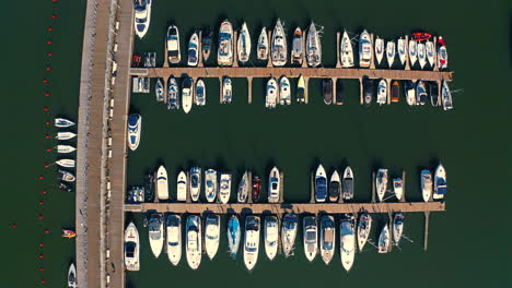 top bird eye view, drone above the marina with luxurious yachts and motorboats at the sunset