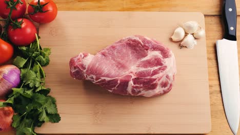 raw pork chops and vegetables ready for cooking