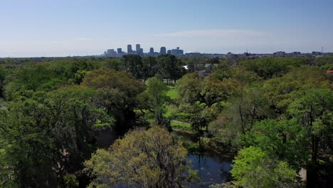 droning towards the city of new orleans from cafe du monde at city park