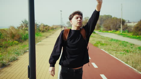 man trying to stop a taxi while waiting outdoor to return home