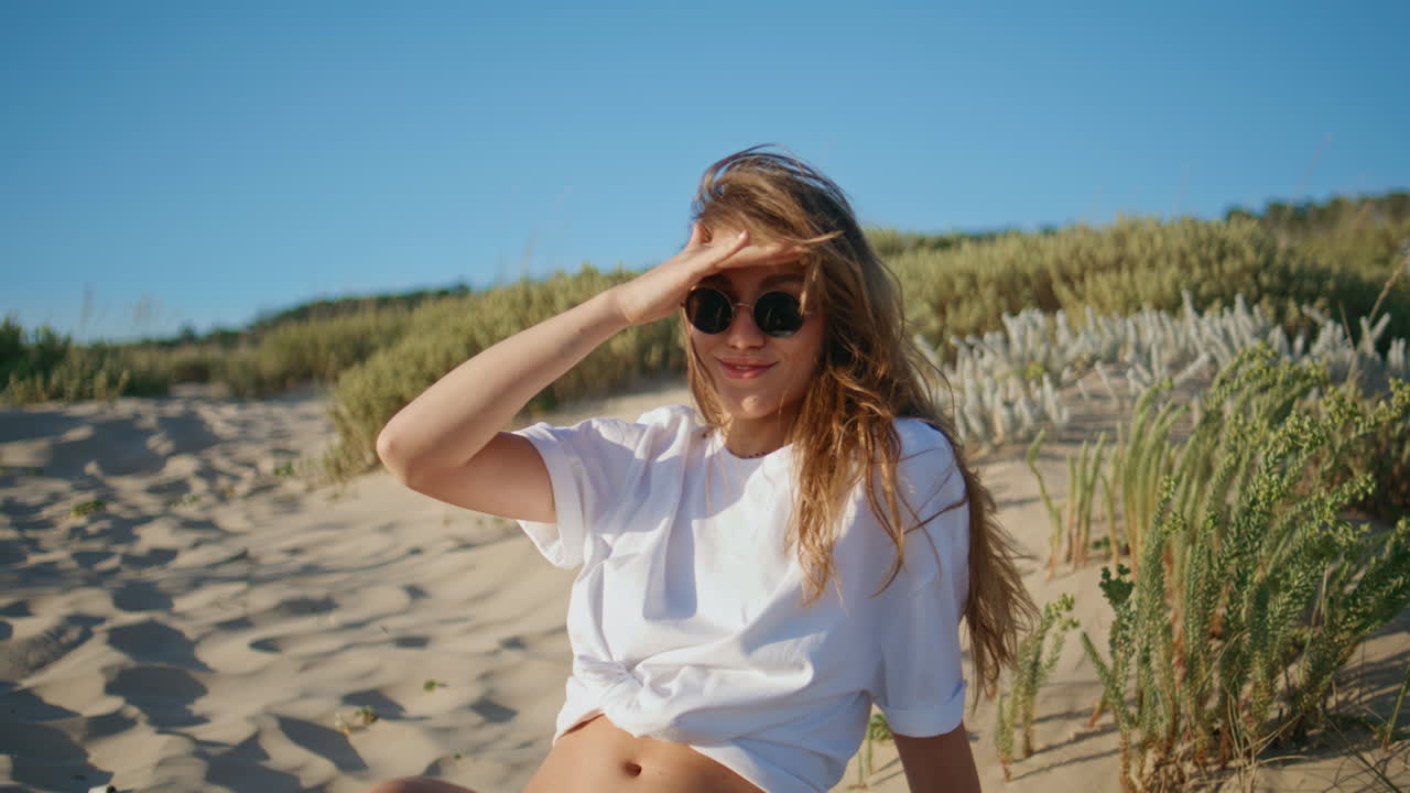 Lazy woman covering sunshine sitting beach closeup. Girl in sunglasses relaxing