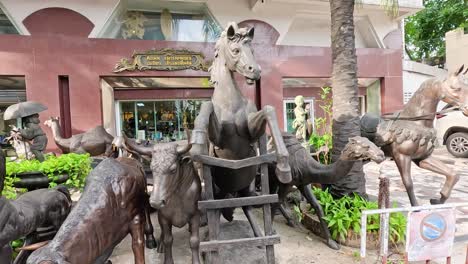 bronze animal statues outside an asian shop