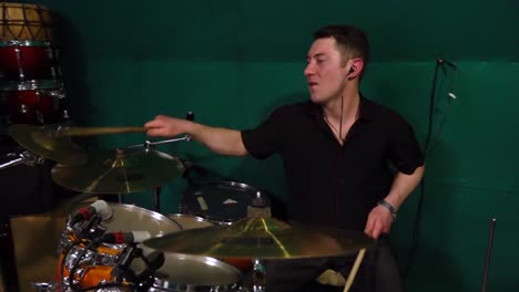 drummer playing drums in a music studio