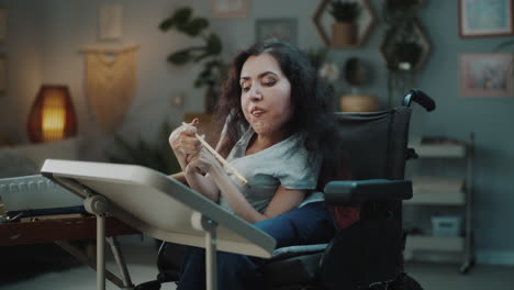 woman in wheelchair working on crafts